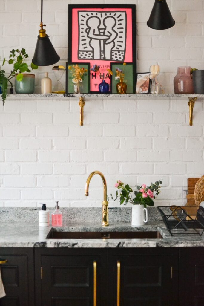 Kitchen sink. Harvey Jones Kitchen with copper sink, marble worktop and gold boiling water tap with shelf.